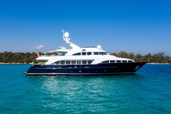 Beautiful shot of the yacht sailing on the water with a blue sky in the background